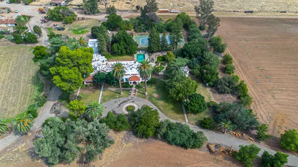 an aerial view of a house with outdoor space and lake view