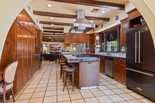 wooden table and chairs in a hall with a large window