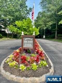 a sign that is in front of flowers