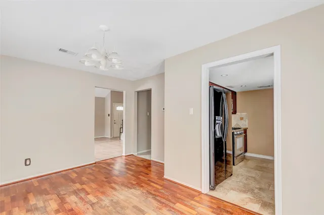 a view of a room with a stylish ceiling fan and entryway