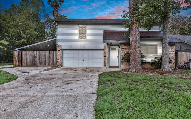 a front view of a house with a garden and yard
