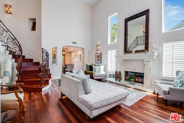 a dining room with furniture window and wooden floor