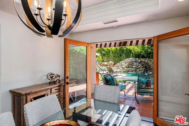 a view of a wooden deck with chairs and a yard