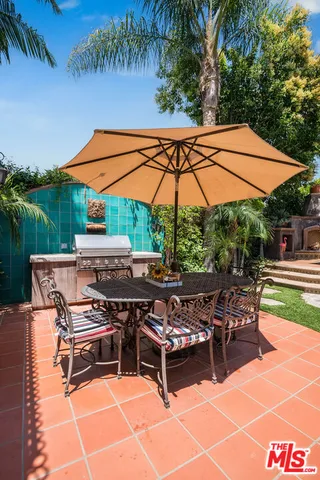a view of a house with backyard sitting area and swimming pool