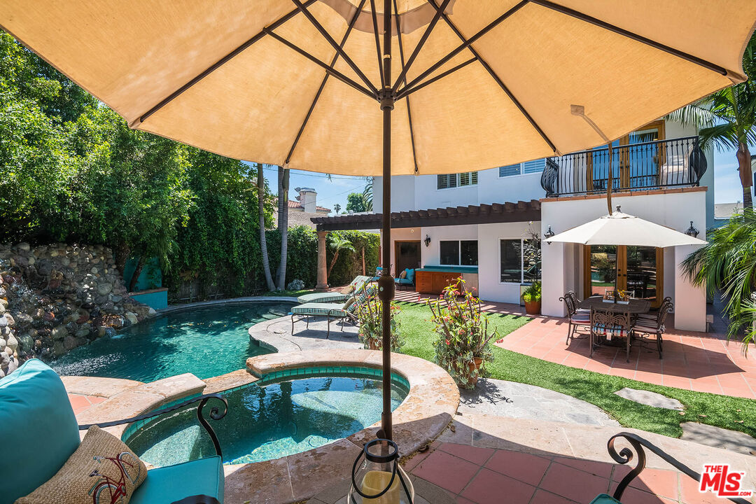 4520 Tyrone Avenue Sherman Oaks, CA 91423 - Photo 23 of 61 a view of a patio with table and chairs under an umbrella