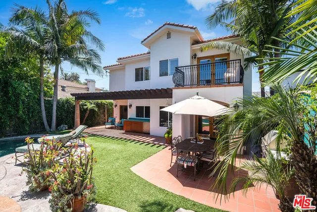 a kitchen with stainless steel appliances granite countertop a sink a stove and a wooden floors