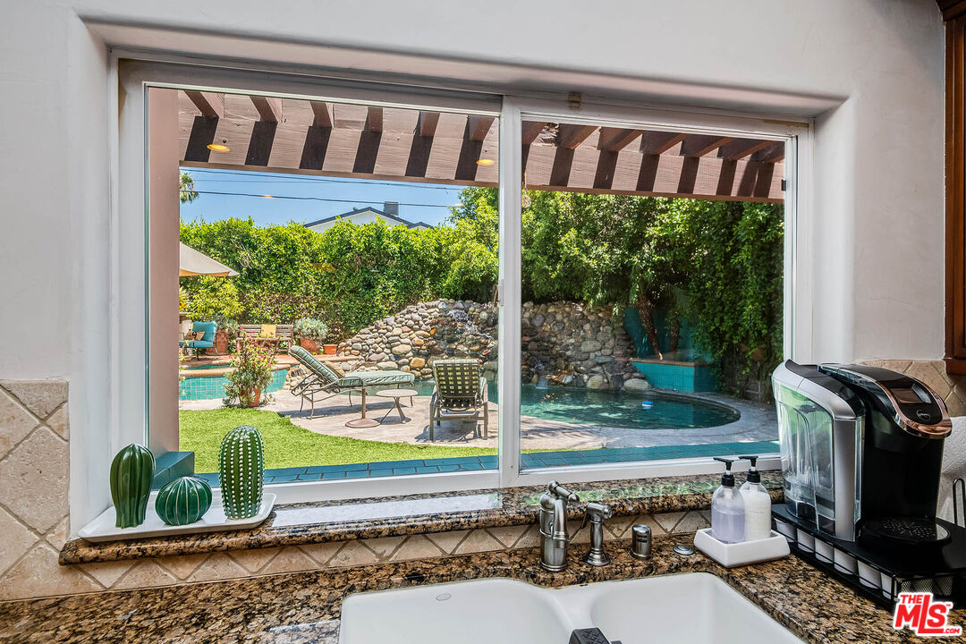 4520 Tyrone Avenue Sherman Oaks, CA 91423 - Photo 30 of 61 a living room filled with furniture and a floor to ceiling window