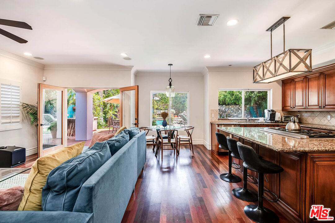 4520 Tyrone Avenue Sherman Oaks, CA 91423 - Photo 33 of 61 a living room with stainless steel appliances granite countertop lots of wooden furniture large window wooden floor and furniture