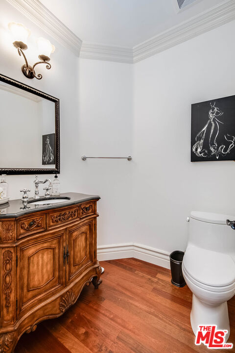 4520 Tyrone Avenue Sherman Oaks, CA 91423 - Photo 40 of 61 a bathroom with a toilet a sink and mirror