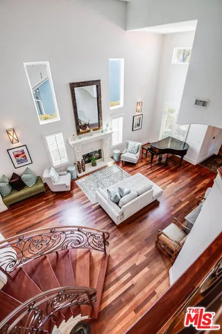 a living room with furniture window and wooden floor