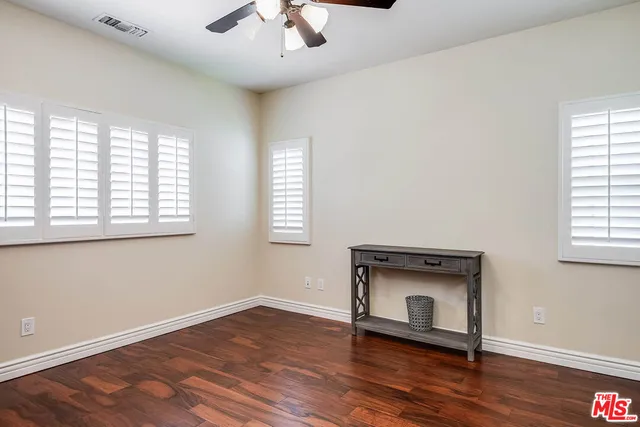 a spacious bathroom with a granite countertop sink and a mirror