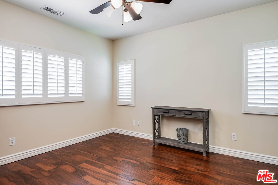 4520 Tyrone Avenue Sherman Oaks, CA 91423 - Photo 49 of 61 an empty room with wooden floor and windows