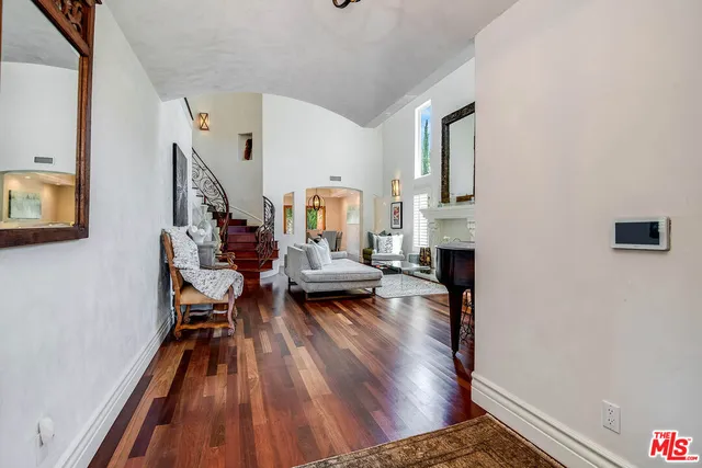a living room with fireplace furniture and a wooden floor