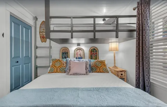 a bedroom with a bed and a window