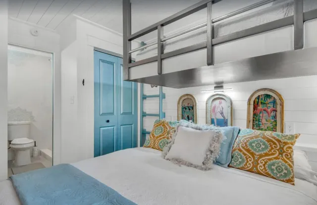 a bedroom with a bed and glass door