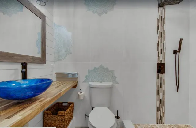 a bathroom with a sink toilet and a mirror