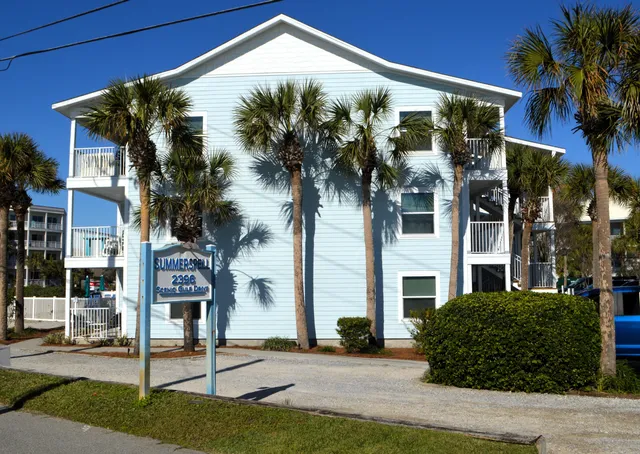 a front view of a building with a garden