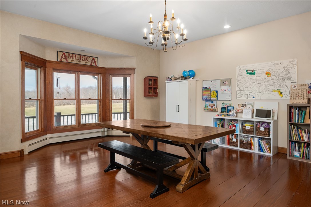 9419 Robinson Road Chardon, OH 44024 - Photo 6 of 46 Dining room featuring a baseboard radiator, dark wood-type flooring, and hanging lights