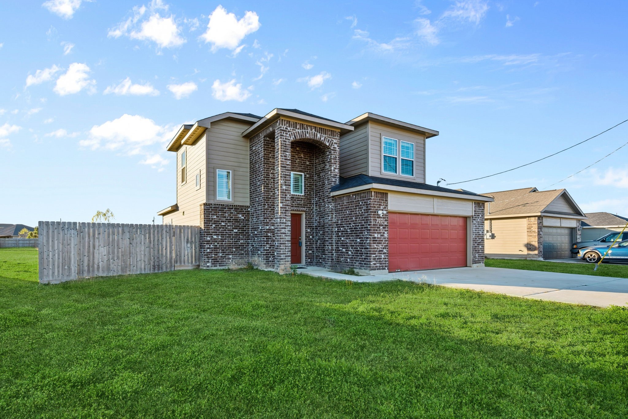 727 Road 5105 Cleveland, TX 77327 - Photo 1 of 22 a front view of a house with a yard and garage