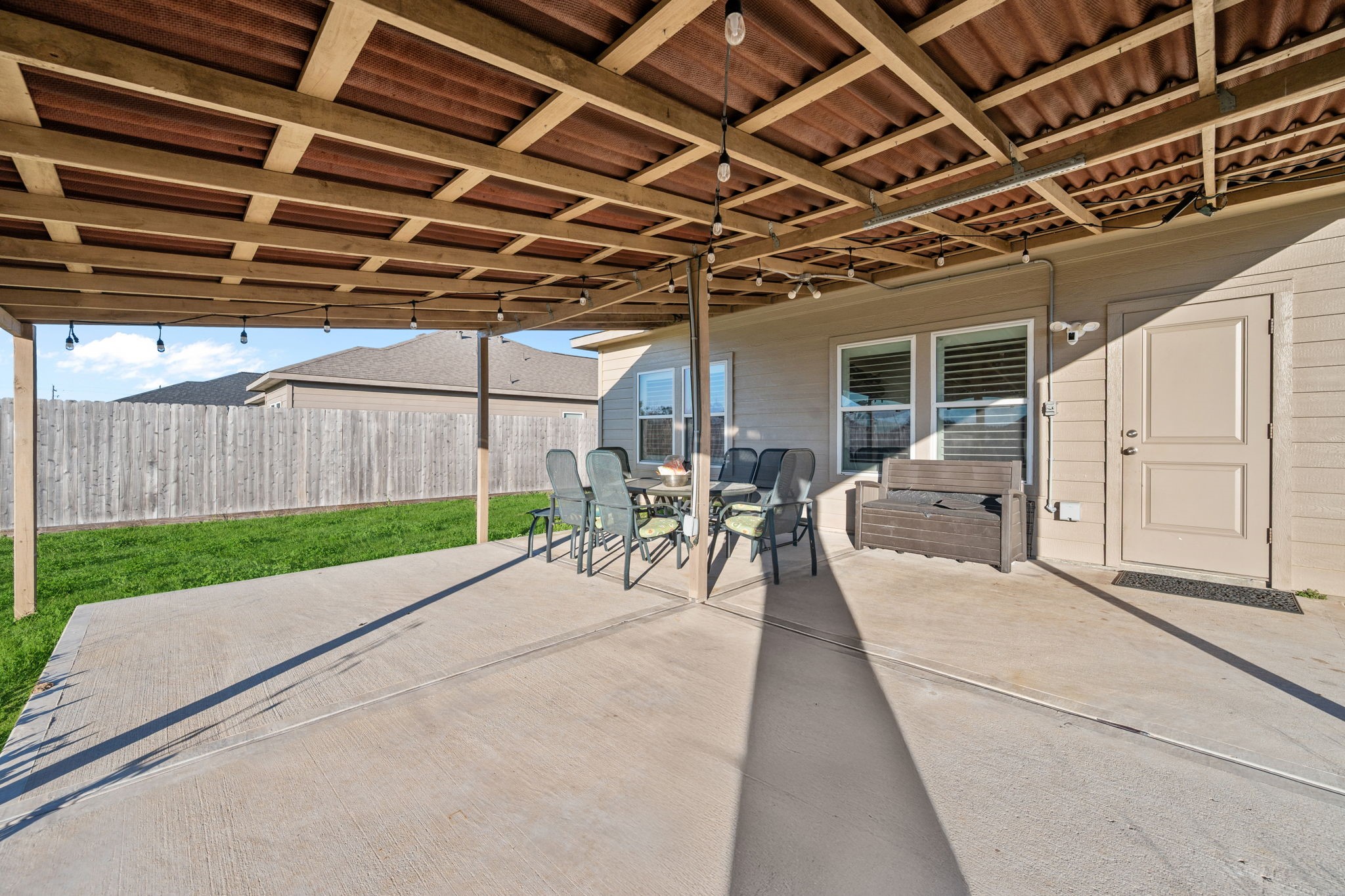 727 Road 5105 Cleveland, TX 77327 - Photo 18 of 22 a view of a backyard with table and chairs with wooden fence