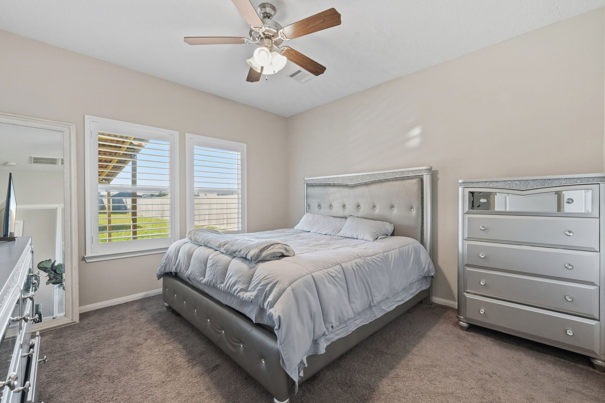 727 Road 5105 Cleveland, TX 77327 - Photo 10 of 22 a bedroom with a bed and a chandelier