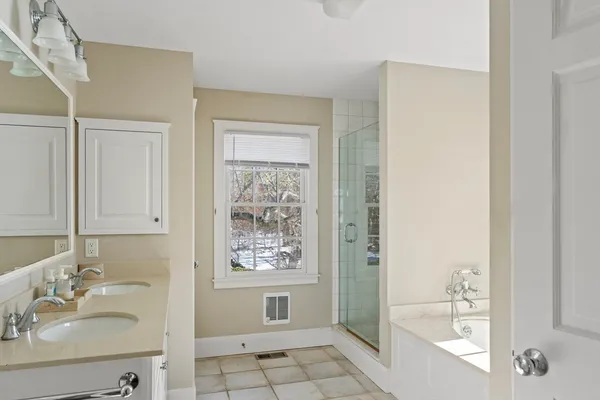a bathroom with a bathtub a sink and a mirror