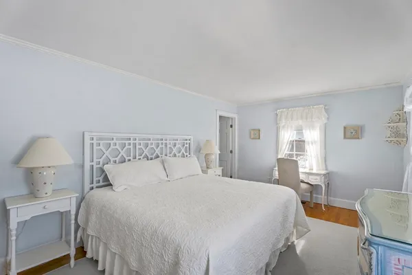 a bedroom with a bed and a lamp