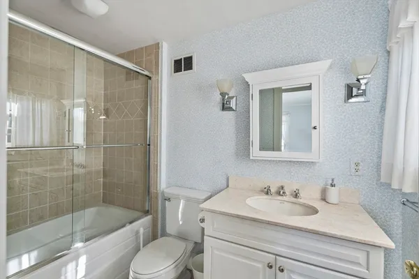 a bathroom with a sink toilet and shower