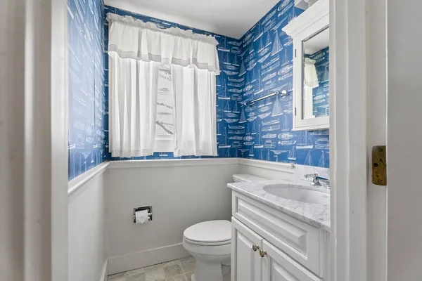 a bathroom with a granite countertop toilet a sink and a bathtub