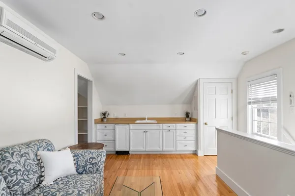 a large white kitchen with cabinets