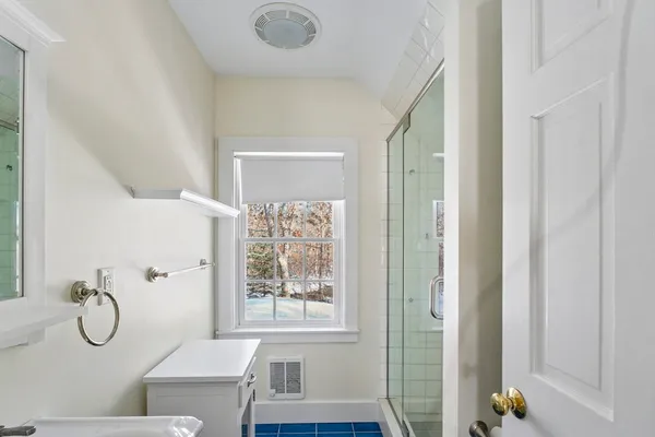 a bathroom with a granite countertop mirror and a shower