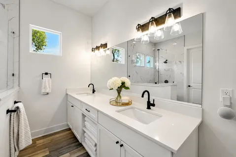 a bathroom with a sink a toilet and mirror