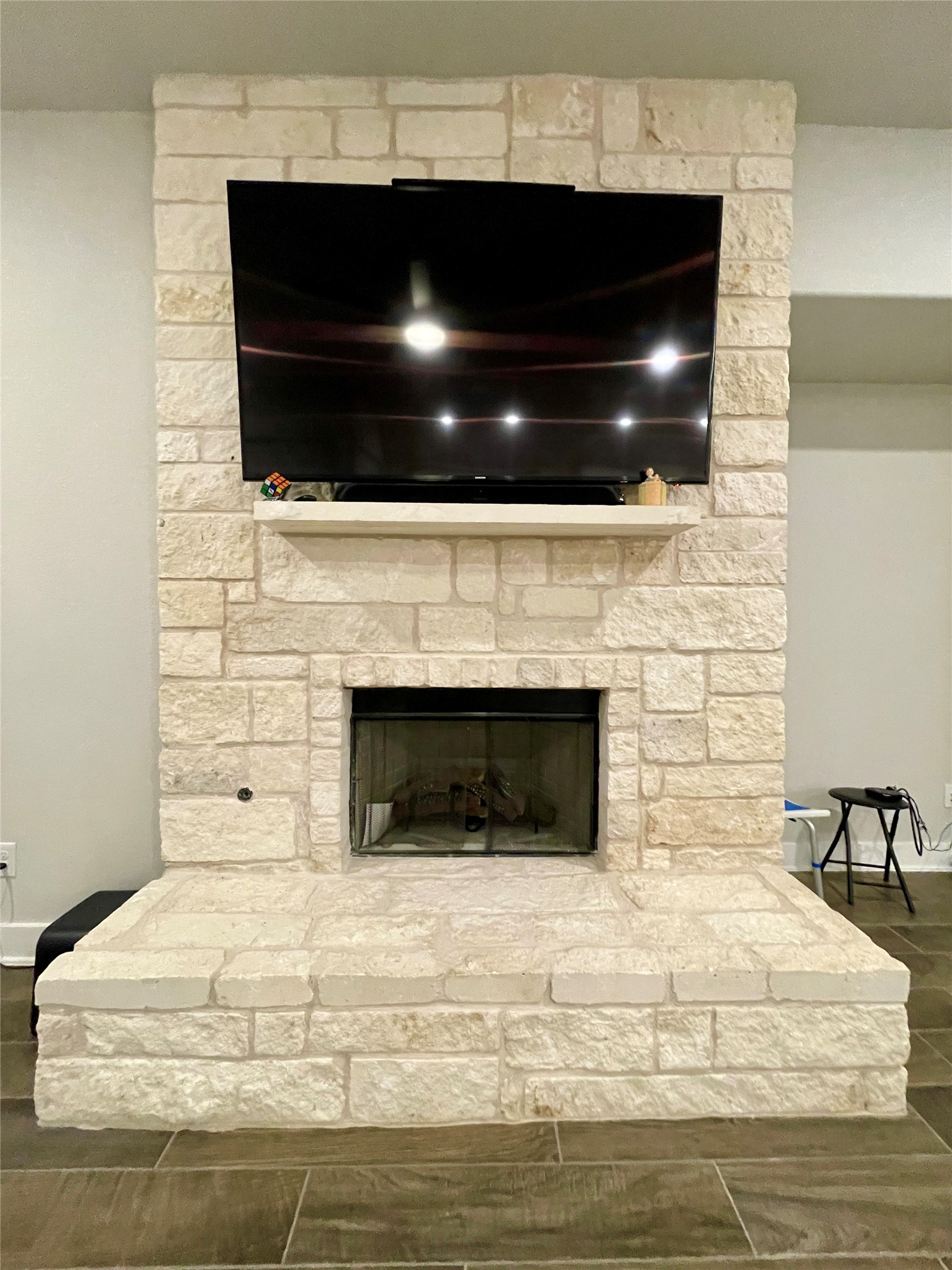 120 Sail Wind Way Georgetown, TX 78633 - Photo 10 of 25 a living room with a fireplace and a flat screen tv