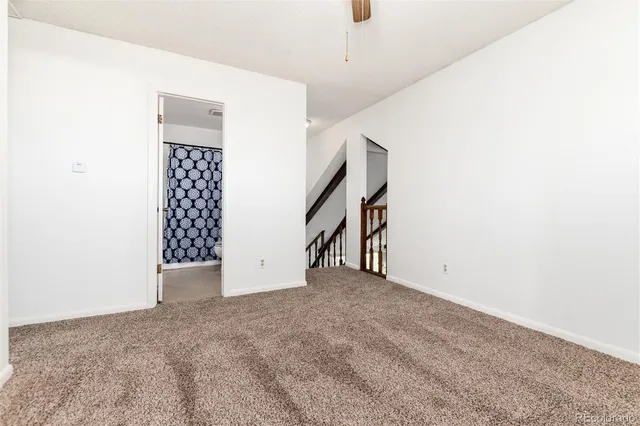 a view of an empty room with stairs