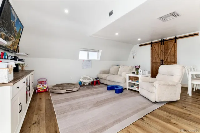 a bedroom with furniture and a flat screen tv