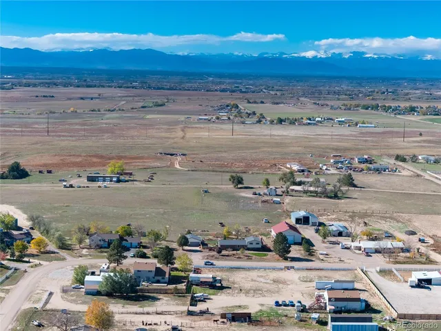a front view of house with lake view and trees in the background