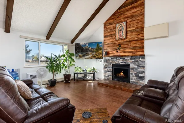 a living room with furniture fireplace and a fireplace