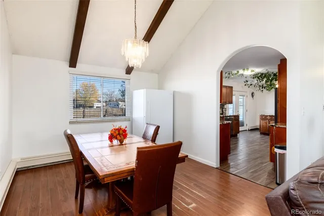 a dining room with furniture and wooden floor