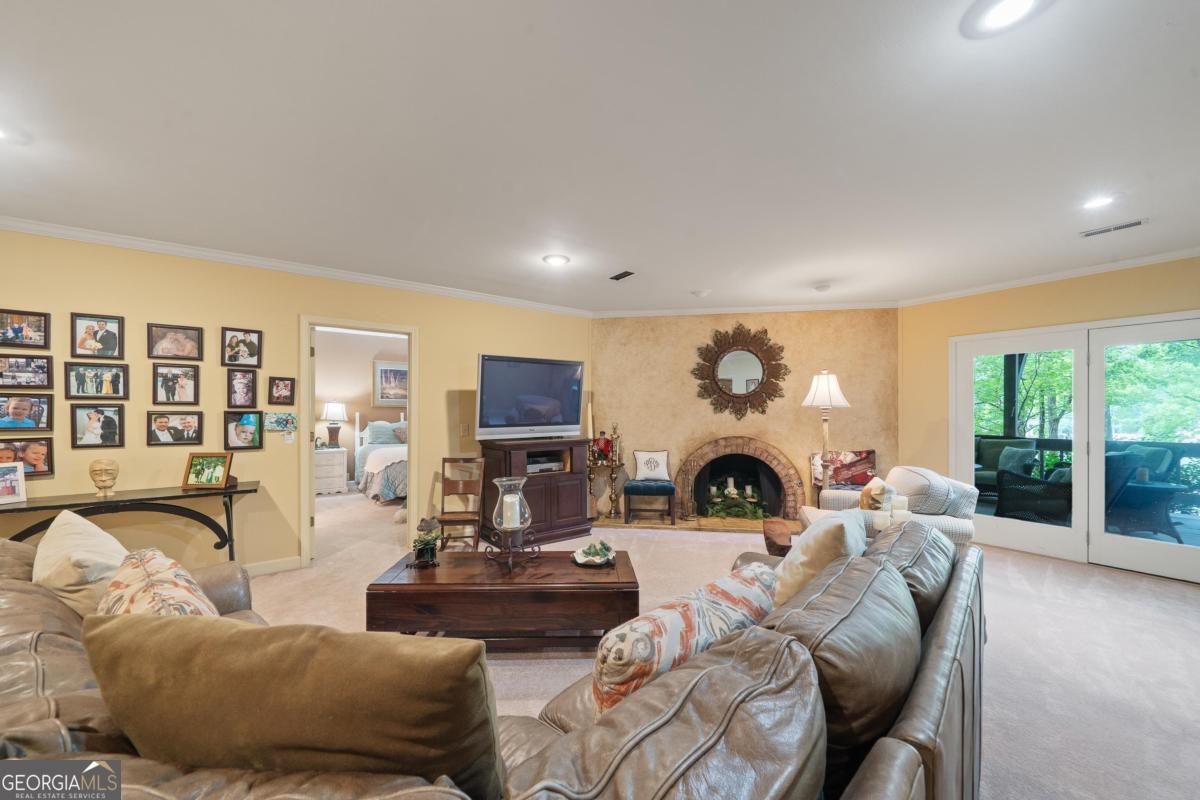 1031 Old Still Road Greensboro, GA 30642 - Photo 49 of 73 a living room with furniture large window and fireplace