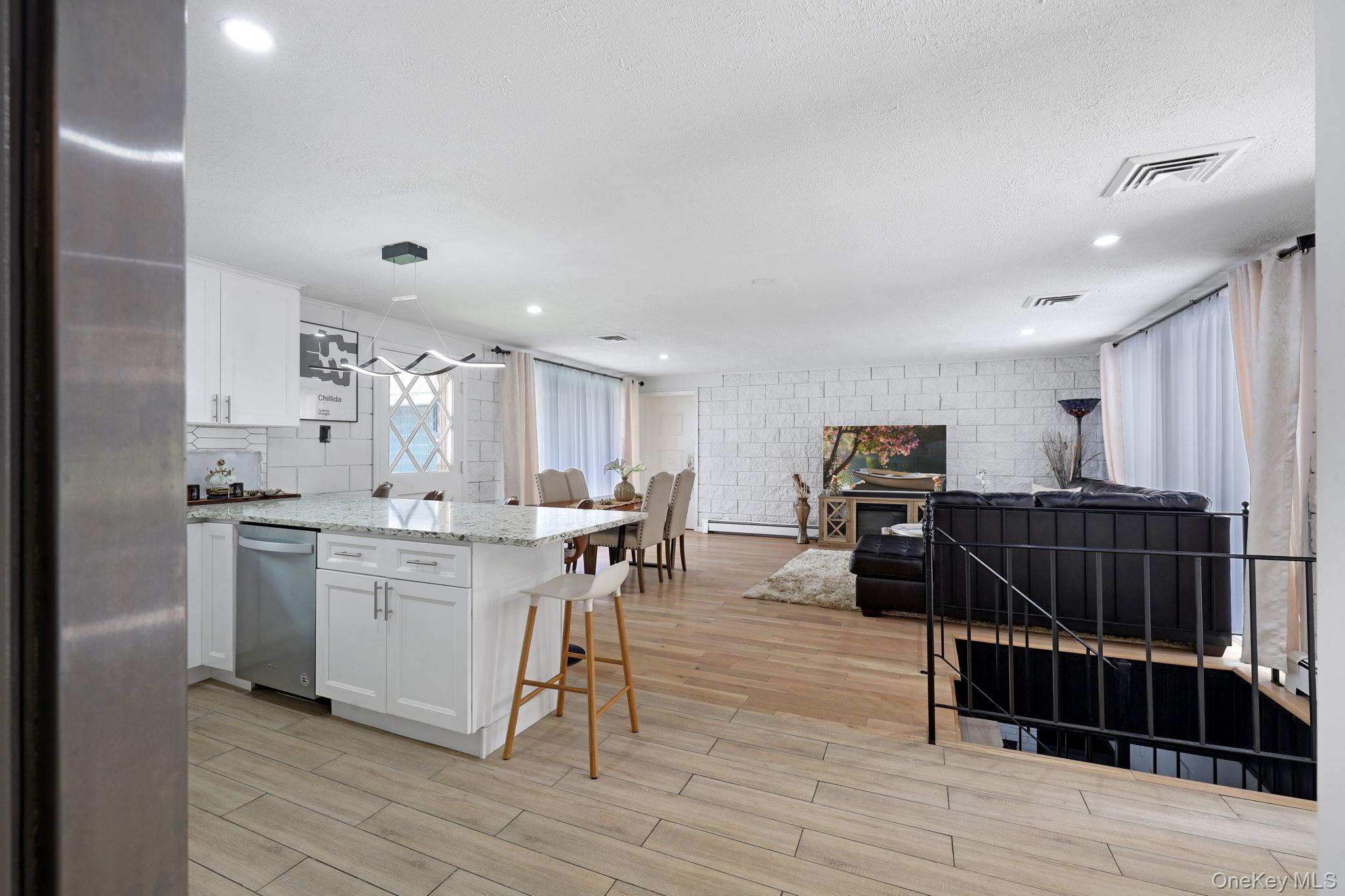 35 Kroeger Road Monticello, NY 12701 - Photo 7 of 29 a living room with kitchen island furniture and a wooden floor