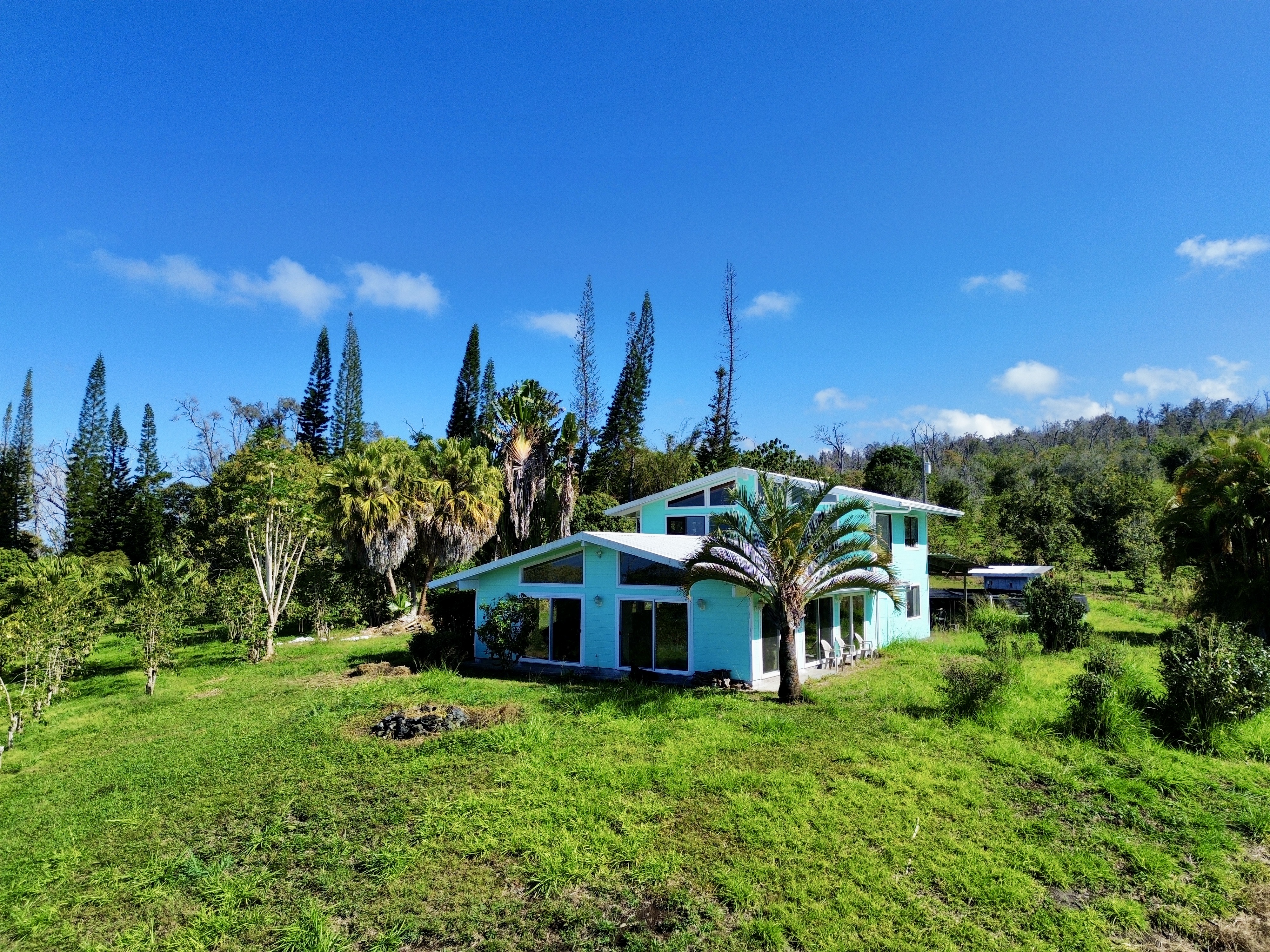 a yellow house with trees in front of it