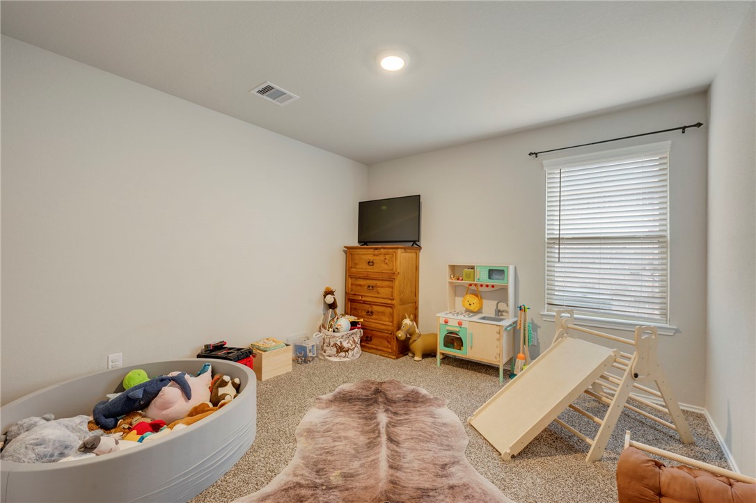 8026 Front Nine Lane Navasota, TX 77868 - Photo 12 of 22 a living room with furniture and a flat screen tv