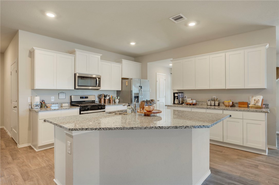 8026 Front Nine Lane Navasota, TX 77868 - Photo 4 of 22 a kitchen with sink a stove and cabinets