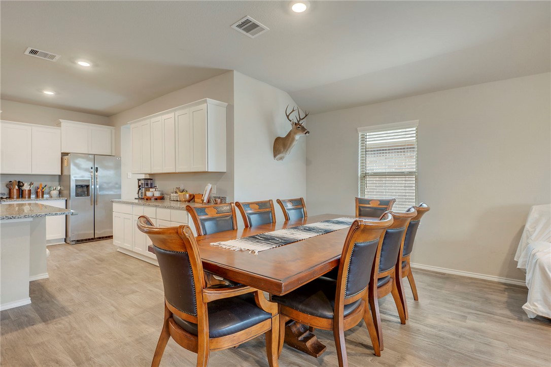 8026 Front Nine Lane Navasota, TX 77868 - Photo 6 of 22 a view of a dining room with furniture and wooden floor