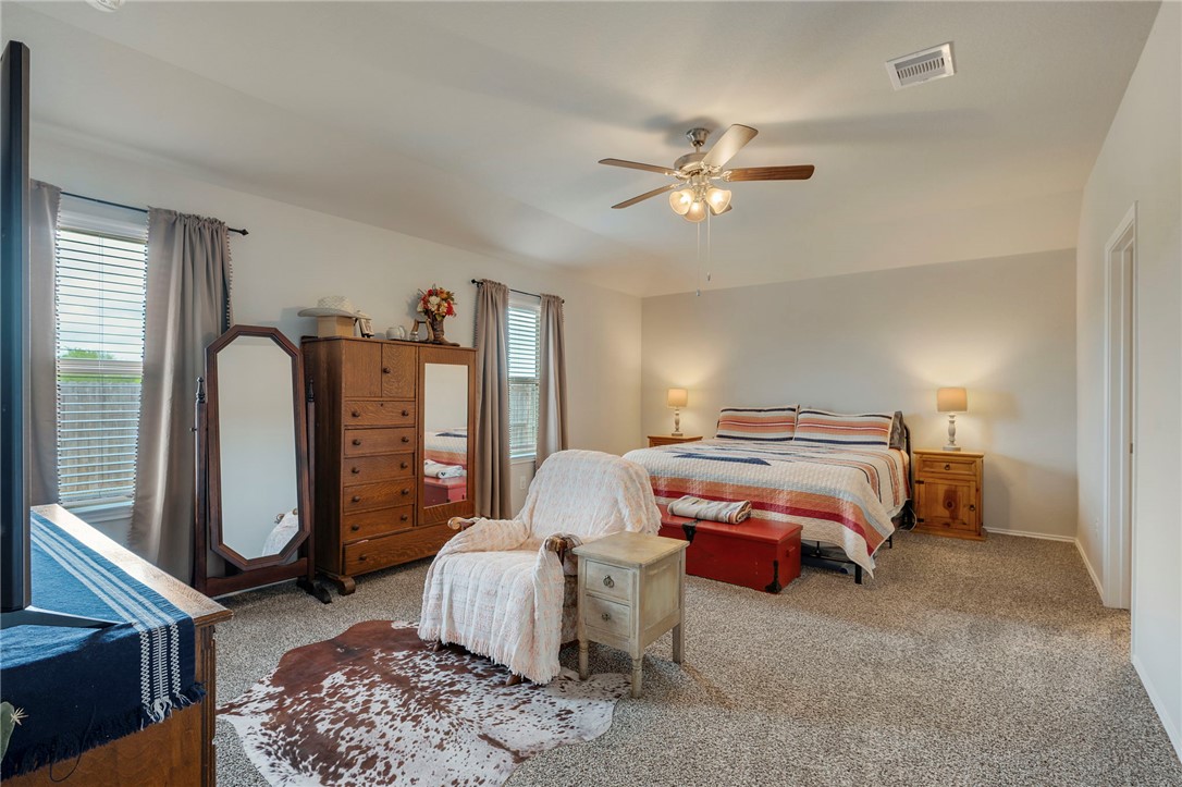 8026 Front Nine Lane Navasota, TX 77868 - Photo 9 of 22 a bedroom with a bed and ceiling fan