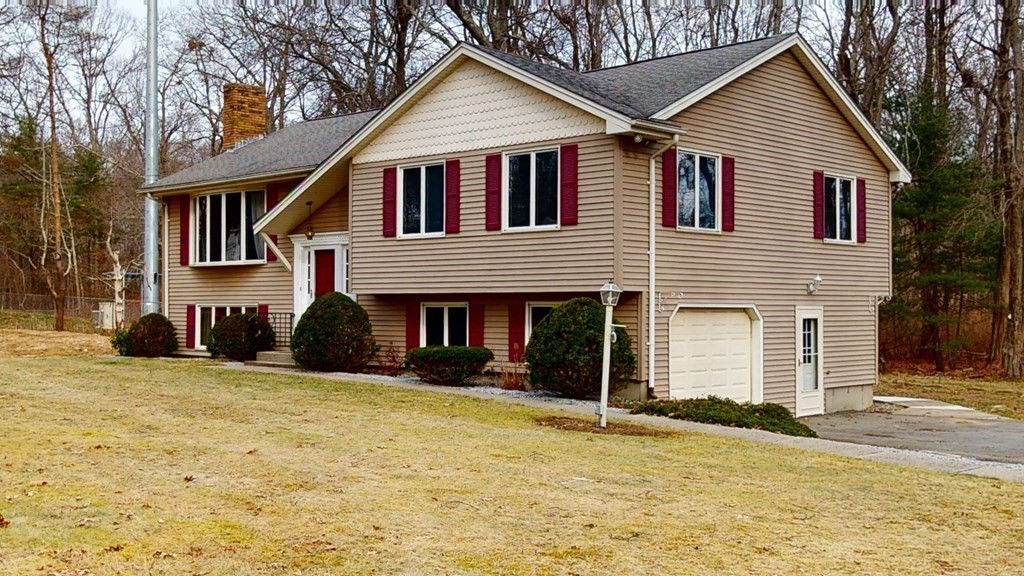 91 Dodge Hill Road Sutton, MA 01590 - Photo 1 of 42 a view of a house with a yard and large tree