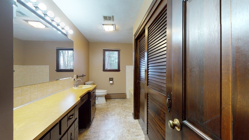 91 Dodge Hill Road Sutton, MA 01590 - Photo 24 of 42 a bathroom with a sink and a mirror