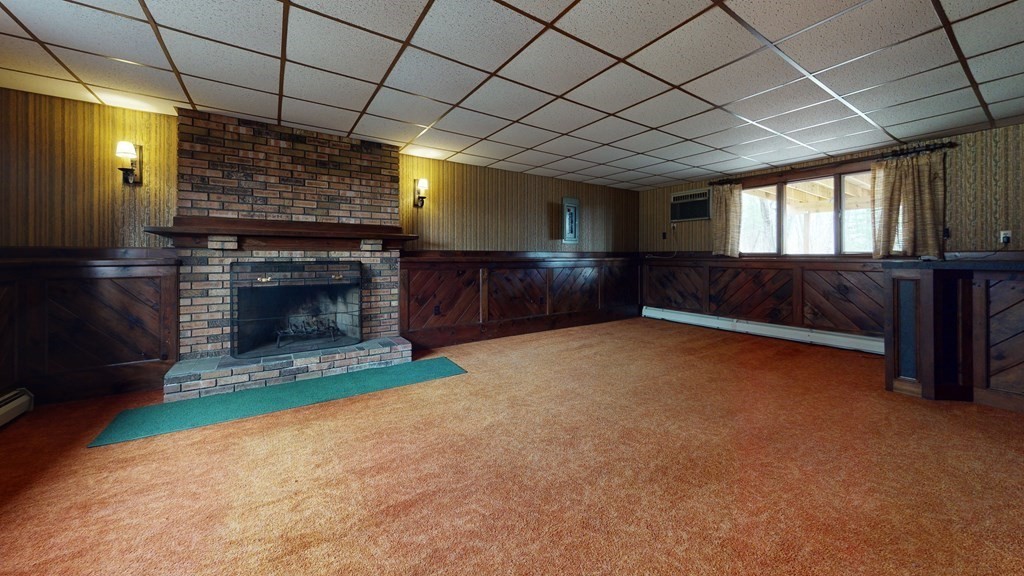 91 Dodge Hill Road Sutton, MA 01590 - Photo 30 of 42 a living room with furniture and a fireplace