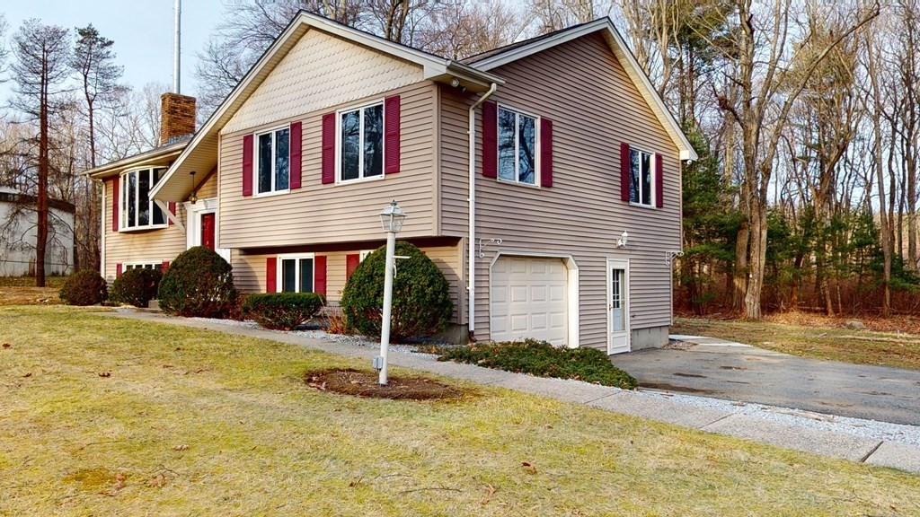 91 Dodge Hill Road Sutton, MA 01590 - Photo 3 of 42 a front view of a house with a yard and garage