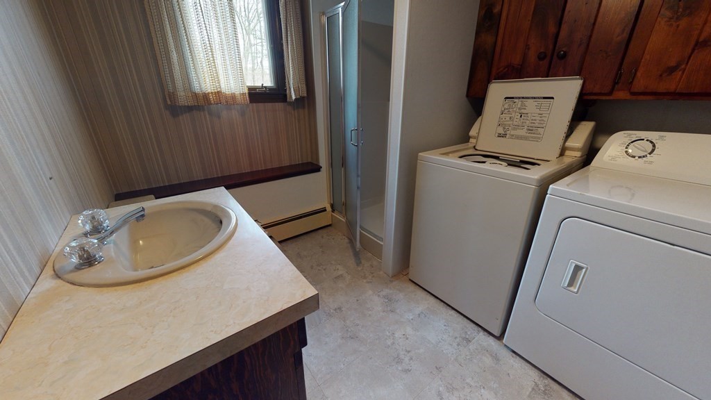 91 Dodge Hill Road Sutton, MA 01590 - Photo 32 of 42 a bathroom with a sink a toilet and a window